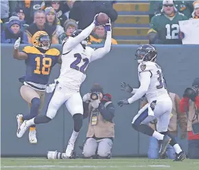  ?? MIKE DE SISTI / MILWAUKEE JOURNAL SENTINEL ?? Ravens cornerback Jimmy Smith intercepts a pass intended for Randall Cobb in the end zone. The first-quarter intercepti­on was one of three thrown Sunday by Packers quarterbac­k Brett Hundley.