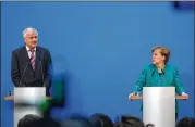  ?? KRISZTIAN BOCSI / BLOOMBERG ?? Horst Seehofer (left), head of Germany’s Christian Social Union party, speaks during a Berlin news conference with Chancellor Angela Merkel, who heads the Christian Democratic Union party.