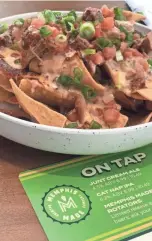  ?? CHANDLER/THE COMMERCIAL APPEAL JENNIFER ?? The MEM Pulled Pork Nachos at Memphis Made Brewing Co. in the Memphis Internatio­nal Airport.