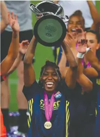  ?? CLIVE BRUNSKILL/AFP/ FILES ?? Lyon's Canadian defender Kadeisha Buchanan raises the trophy after the UEFA Women's Champions League final.