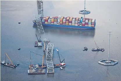  ?? /Reuters ?? Crumpled: A view of the Dali cargo vessel, which crashed into the Francis Scott Key Bridge in Baltimore in March. The Dali hit one of the bridge’s support pillars, causing nearly the entire structure to crash into the water within seconds with the loss of six lives.