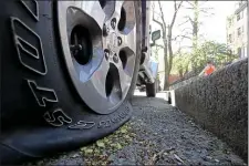  ?? STUART CAHILL — BOSTON HERALD ?? SUVs in the area of Mount Vernon that had their tires flattened by environmen­tal activists.