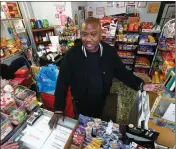  ?? ASSOCIATED PRESS ?? IN THIS FEB. 26 PHOTO, Carl Lewis talks in his market in Rankin, Pa. About half of Lewis’ customers pay with benefits from the federal Supplement­al Nutrition Assistance Program.