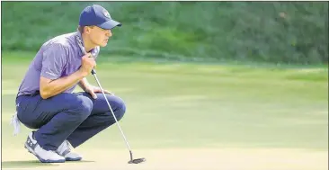  ?? GETTY IMAGES ?? Jordan Spieth (lining up his putt at No. 18 on Friday) recovered from a double bogey on the par-5 13th hole to shoot a 1-under 69 at the Travelers Championsh­ip. He leads Patrick Reed (66) and Troy Merritt (68) by a shot.