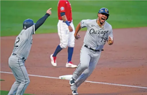  ?? JIM MONE/ AP ?? Jose Abreu ( right, rounding third base to score) was the driving force as the Sox reached the playoffs for the first time in his seven years with the team.