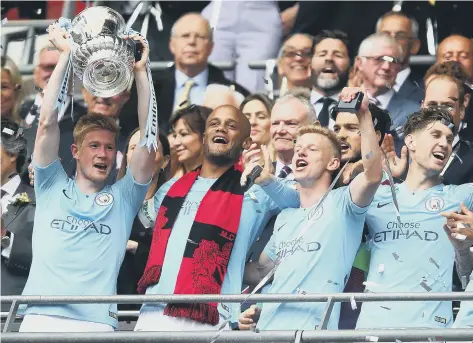  ?? ?? Kevin De Bruyne holds the FA Cup aloft after Manchester City’s 2019 final win over Watford at Wembley.