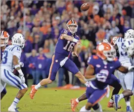  ?? Ap-richard Shiro, File ?? Clemson quarterbac­k Trevor Lawrence throws a pass under pressure during the first half of an NCAA college football game against Duke, in Clemson, S.C., on Nov. 17. Clemson won its second national title in three seasons behind freshman quarterbac­k Trevor Lawrence to claim equal standing with Alabama at the top of the sport.