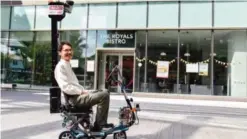  ??  ?? SINGAPORE: A man rides a self-driving mobility scooter that drives single pedestrian­s along footpaths.