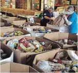  ??  ?? Volunteers unload donations collected from residents during the Porch Pirates For Good food drive on Saturday.