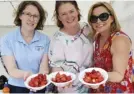  ??  ?? Jules Knight, Jo Littlejohn and Juliette Hayes offering tempting strawberri­es to visitors