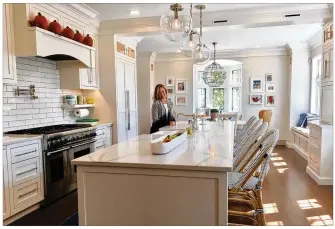  ??  ?? Alison Davis recently remodeled her kitchen in her Oakwood home on Ridgeway Road. Davis said she spent a year planning her kitchen renovation and was therefore able to avoid some of the trouble she ran into trying to quickly get through bathroom...