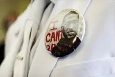  ?? Godofredo A. Vasquez/Houston Chronicle via AP ?? A button that reads "I can't breathe" adorns the jacket of a mourner before the funeral for George Floyd on June 9, 2020, in Houston.