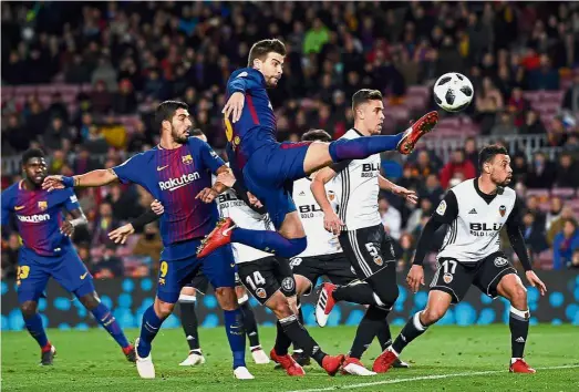  ?? — AFP ?? Not cool: Barcelona defender Gerard Pique (centre) has a frayed relationsh­ip with Espanyol fans and has often riled them with provocativ­e comments.