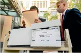  ?? AP ?? Members of Epic Games’ legal team roll exhibit boxes into the Ronald V Dellums building in Oakland, California, for the company’s lawsuit against Apple.