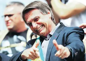  ?? HEULER ANDREY / AFP / GETTY IMAGES ?? Right-wing populist presidenti­al candidate Jair Bolsonaro, a former army captain, has repeatedly praised Brazil’s two-decade-long military dictatorsh­ip and has called a convicted torturer from that time “a Brazilian hero.”