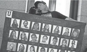  ?? ERIC GAY/AP FILE ?? Abel Lopez, right, father of Xavier Lopez who was killed in the shootings in Uvalde, Texas, holds a banner May 8 in Austin, Texas. Families in Uvalde are digging in for a new test of legal protection­s for the gun industry as they mark one year since the shooting.