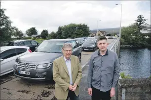  ?? Photograph­y. Photograph: Abrightsid­e ?? Mike MacGruer, left, and Elliot Brown at the Lochy Bridge, a traffic pressure point.