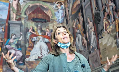  ??  ?? Vatican Museums director Barbara Jatta stands in front of the oil-painted feminine figure known as Allegory of Justice, left, in the Hall of Constantin­e, now believed to be by Raphael