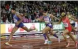  ?? MATTHIAS SCHRADER — THE ASSOCIATED PRESS ?? United States’ gold medal winner Phyllis Francis, left, crosses the line ahead of Bahrain’s silver medal winner Salwa Eid Naser, right, and United States’ bronze medal winner Allyson Felix in the women’s 400-meter final London Wednesday. in