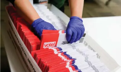  ??  ?? Election workers sort vote-by-mail ballots for the presidenti­al primary in Renton, Washington. Many voters will have cast their ballots for candidates no longer in the race. Photograph: Jason Redmond/AFP via Getty Images