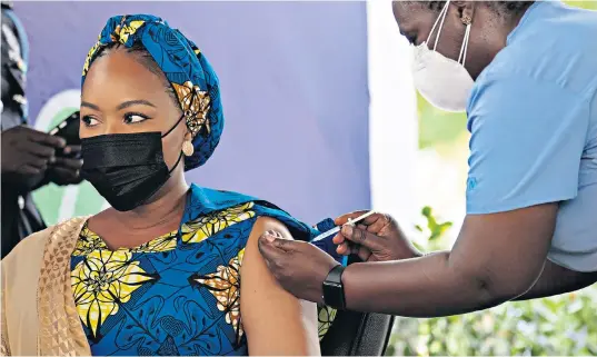  ??  ?? Samira Bawumia, the Second Lady of Ghana, receives a dose of the vaccine supplied by the Covax programme in Accra. She is married to Mahamudu Bawumia, the vice-president