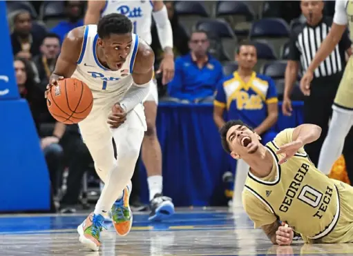  ?? Matt Freed/Post-Gazette ?? “If I was to play a little bit better than I did this year, we would have been way better,” said sophomore guard Xavier Johnson, stealing the ball in front of Georgia Tech’s Michael Devoe. In 2018-19 he became the first Panthers player to make the ACC all-freshman team.