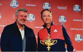  ?? USA TODAY Sports ?? Europe team captain Darren Clarke (left) and Team USA captain Davis Love III pose after the captains’ press conference ahead of the 41st Ryder Cup at Hazeltine National Golf Club.