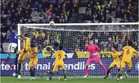  ?? — AFP ?? MELBOURNE: Diego Andrade (L) of Brazil scores his second goal during the friendly internatio­nal football match between Brazil and Australia in Melbourne yesterday.