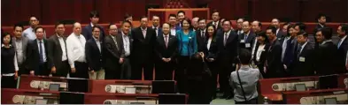  ??  ?? Central government’s top liaison official in Hong Kong Wang Zhimin (center) meets with the 51 lawmakers who attended the luncheon.