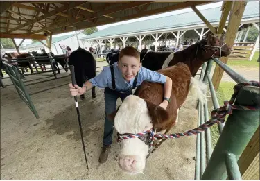  ?? PHOTOS BY MARAH MORRISON — THE NEWS-HERALD ?? Seamus Bly of Leroy Township has been a 4-H’er for eight years. He enjoys working with the steers, watching them grow and improve their skills.