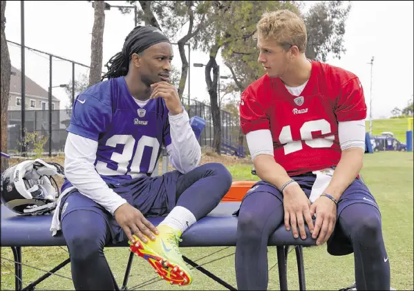  ?? MARK J. TERRILL / AP ?? Former UGA star Todd Gurley (30) gets to know his new Rams teammate and quarterbac­k, No. 1 overall draft pick Jared Goff.