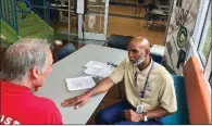  ?? Arkansas Democrat-Gazette/RACHEL HERZOG ?? Dwight Pridgeon (right), re-entry coordinato­r for the city of Little Rock, talks recently with Michael O’Donnell, who applied for a temporary job assisting with flood cleanup.