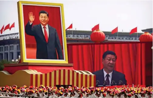  ?? File/associated Press ?? Participan­ts cheer beneath a large portrait of Chinese President Xi Jinping during a parade to commemorat­e the 70th anniversar­y of the founding of Communist China in Beijing.