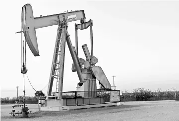  ??  ?? A pump jack operates at a well site leased by Devon Energy Production Company near Guthrie, Oklahoma. — Reuters photo