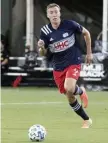  ?? aP File ?? BIG ADDITION: Revolution striker Adam Buksa moves the ball against Montreal on July 9.