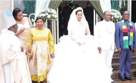  ?? ?? President Mnangagwa and First Lady Dr Auxillia Mnangagwa pose for a photograph with newly-weds — Vice President Constantin­o Chiwenga and wife Colonel Miniyothab­o Baloyi-Chiwenga — while Bishop Rudolph Nyandoro (left), who solemnised the wedding, looks on at St Gerard’s Catholic Church in Harare yesterday. — Picture: Justin Mutenda; More pictures on Page 6