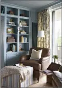  ?? AP/SHERRY MOELLER/ ANGIE SECKINGER ?? In a home library designed by Kelley Proxmire in Washington, D.C., an ottoman helps turn a comfortabl­e chair into the perfect place for reading.