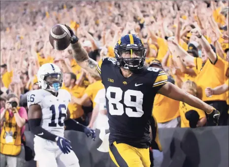  ?? Matthew Putney / Associated Press ?? Iowa receiver Nico Ragaini reacts after scoring a touchdown in front of Penn State safety Ji’Ayir Brown during the second half Saturday.