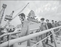  ??  ?? Crew members of ONGC's Barge P305 who were stranded off the Mumbai shore come out of INS Kochi on Wednesday after they were rescued by the Indian Navy.