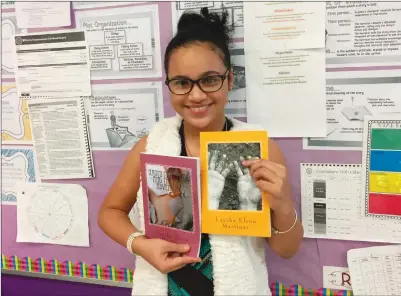  ?? Photos by Jonathan Bissonnett­e ?? Eleven-year-old Laysha Elena Martinez holds copies of her two books in her ‘Naomi Cathaway’ series of fantasy fiction novels. The Central Falls resident began writing when she was a fourth-grade student at Veterans Memorial Elementary School.