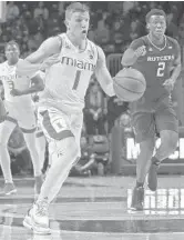  ?? PATRICK FARRELL/MIAMI HERALD ?? UM’s DJ Vasiljevic breaks away down the court as Miami hosted Rutgers on Wednesday night in the ACC/Big Ten Challenge. The Hurricanes lost 57-54.