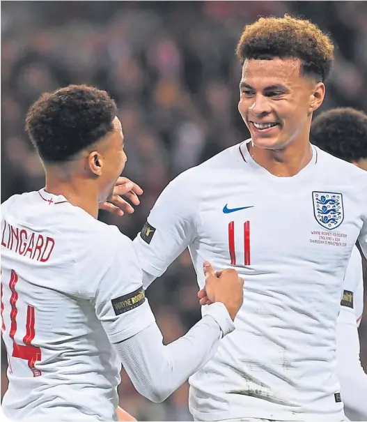  ??  ?? Ecstasy. Dele Alli celebrates with Jesse Lingard after helping set up England’s opener against the United States on Thursday night . . .