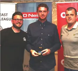  ??  ?? Stewart Barnett and Robbie McDonnell, representi­ng Rathmullen Celtic, being presented with a Division 3 winners medal by Barry Ferguson, FAI Developmen­t Office.