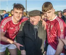  ??  ?? Shamrock Gaels players , James Carroll and Dillon McDermott celebrate their victory with one of their longest serving officials P.J. Quigley