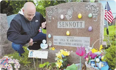  ?? STAFF PHOTO BY ANGELA ROWLINGS ?? SEEKING JUSTICE: Joseph Amoroso pauses yesterday by the grave of his daughter, Bella Bond, at Winthrop Cemetery, where she is buried with her great-grandmothe­r.