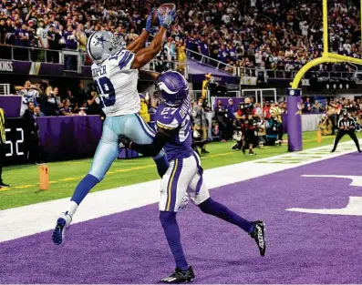  ?? Adam Bettcher / Getty Images ?? Cowboys receiver Amari Cooper catches a 5-yard touchdown pass from backup quarterbac­k Cooper Rush against the Vikings’ Cameron Dantzler during the fourth quarter to seal Sunday night’s victory.