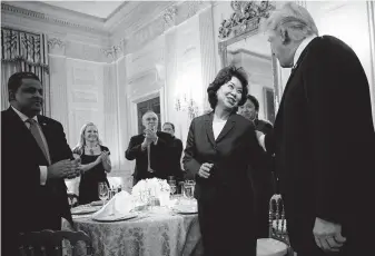  ?? Tom Brenner / New York Times file photo ?? President Donald Trump greets Transporta­tion Secretary Elaine Chao at the White House last June. Energy giants have pushed Trump’s rollback of fuel efficiency rules for automobile­s.