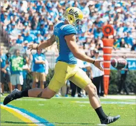  ?? Jason O. Watson Getty Images ?? MATT MENGEL prepares to send the ball aloft in UCLA’s game against Virginia earlier this season. The Bruins also have used Adam Searl as a punter.