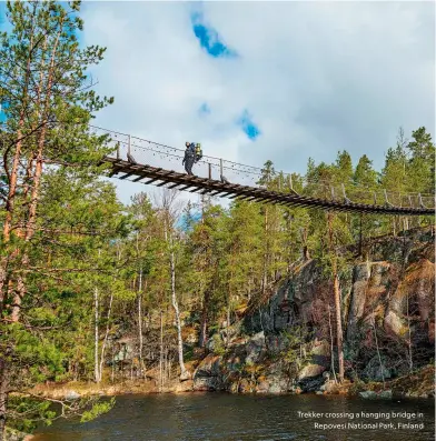  ?? ?? Trekker crossing a hanging bridge in
Repovesi National Park, Finland