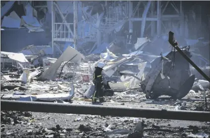  ?? MAX PSHYBYSHEV­SKY/AP ?? AN UKRAINIAN FIREFIGHTE­R WORKS near a destroyed building on the outskirts of Odesa, Ukraine on Tuesday. The Ukrainian military said Russian forces fired seven missiles a day earlier from the air at the crucial Black Sea port of Odesa, hitting a shopping center and a warehouse.